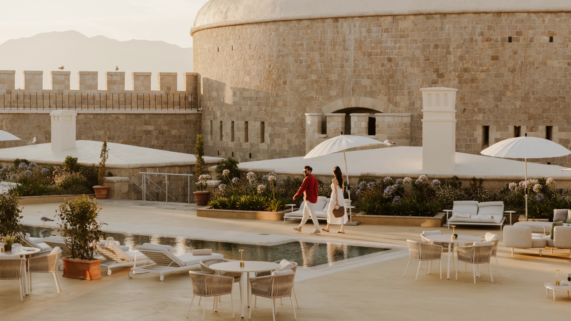 Couple walking at sunset on Mamula Island